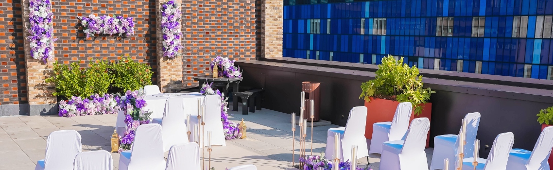 Flowers, chairs and a table set for a ceremony on the Terrace at Tower Hamlets Town Hall