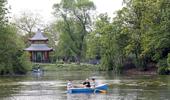 People rowing a boat in front of the Chinese Pagoda