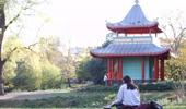 Person sitting in front of the Chinese Pagoda